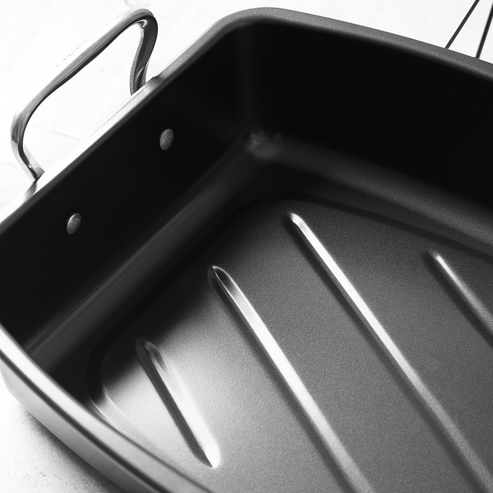 Black roasting pan with handles on a white background
